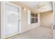 View of the screened-in front porch with ceiling fan and neutral siding at 17068 Se 96Th Chapelwood Cir, The Villages, FL 32162