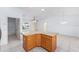 Kitchen island with granite countertops and wood cabinets open to the living area at 17068 Se 96Th Chapelwood Cir, The Villages, FL 32162
