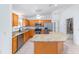 Well-equipped kitchen featuring stainless steel appliances and a granite countertop island at 17068 Se 96Th Chapelwood Cir, The Villages, FL 32162