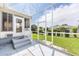 A screened lanai offers seamless indoor-outdoor living with access to a well-maintained backyard and comfortable seating at 17068 Se 96Th Chapelwood Cir, The Villages, FL 32162