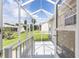 Screened lanai with white trim, offering an inviting outdoor space to enjoy the backyard and sunny weather at 17068 Se 96Th Chapelwood Cir, The Villages, FL 32162