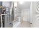 Laundry room features tiled floors and includes both a washer and dryer and wire shelving at 17068 Se 96Th Chapelwood Cir, The Villages, FL 32162