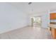 Bright and airy living room featuring tile floors and sliding glass doors to the enclosed patio at 17068 Se 96Th Chapelwood Cir, The Villages, FL 32162