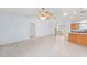 Open-concept living room with tile flooring, ceiling fan, and sliding glass doors to the outdoor patio at 17068 Se 96Th Chapelwood Cir, The Villages, FL 32162