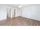 Main bedroom with hardwood flooring, ceiling fan, and access to closets at 17068 Se 96Th Chapelwood Cir, The Villages, FL 32162
