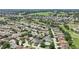 Wide overhead view of homes located next to a golf course, offering lush views at 17108 Se 76Th Creekside Cir, The Villages, FL 32162