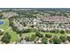 Aerial view with pin shows the house in a verdant golf community near a lake at 17108 Se 76Th Creekside Cir, The Villages, FL 32162