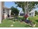 Relaxing backyard with a screened porch, mature trees, and a vibrant garden featuring stone pavers at 17108 Se 76Th Creekside Cir, The Villages, FL 32162