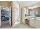 Bathroom with glass shower, cabinets and doorway to main bedroom at 17108 Se 76Th Creekside Cir, The Villages, FL 32162