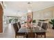 Chic dining area featuring a glass-top table with seating for six and an open view to the living area at 17108 Se 76Th Creekside Cir, The Villages, FL 32162