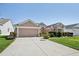 Well-maintained single-story home with an American flag and concrete driveway at 17108 Se 76Th Creekside Cir, The Villages, FL 32162
