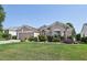 Charming single-Gathering home with a well-manicured lawn and garden, featuring a classic American flag at 17108 Se 76Th Creekside Cir, The Villages, FL 32162