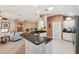 Kitchen island with granite countertops overlooking the living area, perfect for entertaining at 17108 Se 76Th Creekside Cir, The Villages, FL 32162