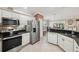Well-equipped kitchen features stainless steel appliances and access to a cozy breakfast nook at 17108 Se 76Th Creekside Cir, The Villages, FL 32162