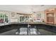 Kitchen island sink with a view into the living area and out to the screened lanai at 17108 Se 76Th Creekside Cir, The Villages, FL 32162