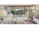 Cozy living space with sliding doors opening to the lanai with outdoor seating and greenery at 17108 Se 76Th Creekside Cir, The Villages, FL 32162