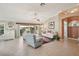 Bright living room with neutral decor, comfortable seating, and access to a screened lanai at 17108 Se 76Th Creekside Cir, The Villages, FL 32162