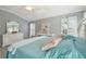 Bright and airy main bedroom with large windows, soft colors, and a spacious feel at 17108 Se 76Th Creekside Cir, The Villages, FL 32162