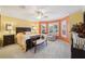 Comfortable main bedroom features a bay window and sitting area at 17108 Se 76Th Creekside Cir, The Villages, FL 32162