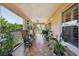 Large covered patio featuring tiled floor, ceiling fans, and outdoor furniture at 17108 Se 76Th Creekside Cir, The Villages, FL 32162