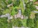 Sprawling property with a lovely pool, manicured lawn, and mature trees at 1930 Country Club Rd, Eustis, FL 32726