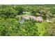 Expansive backyard with a screened pool surrounded by mature trees at 1930 Country Club Rd, Eustis, FL 32726