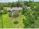 Gorgeous property with a screened-in pool and lush, landscaped yard at 1930 Country Club Rd, Eustis, FL 32726