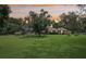 Expansive grassy backyard with a screened-in pool and mature shade trees at 1930 Country Club Rd, Eustis, FL 32726