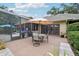 Beautiful backyard featuring a patio, screened-in porch, and well-maintained landscaping at 1930 Country Club Rd, Eustis, FL 32726