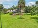 Large, manicured backyard featuring a screened pool and mature landscaping at 1930 Country Club Rd, Eustis, FL 32726