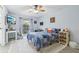 Bright bedroom with cozy blue quilt, ceiling fan, and lots of natural light at 1930 Country Club Rd, Eustis, FL 32726