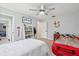 Bright bedroom features modern ceiling fan, white bookshelf, and decorative wall art at 1930 Country Club Rd, Eustis, FL 32726