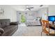 Spacious bedroom with a large window, soft gray accents, and a comfortable sitting area at 1930 Country Club Rd, Eustis, FL 32726