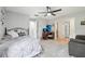 Spacious bedroom featuring large windows, gray decor, and a comfortable sitting area at 1930 Country Club Rd, Eustis, FL 32726