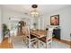 Well-lit dining room with a rustic wood table, hardwood floors, and an open layout connecting to living spaces at 1930 Country Club Rd, Eustis, FL 32726