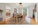 Cozy dining area featuring a rustic wooden table, hardwood floors, and a view into the adjacent kitchen at 1930 Country Club Rd, Eustis, FL 32726