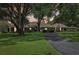 Charming single-story home with mature trees and a circular driveway at 1930 Country Club Rd, Eustis, FL 32726