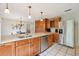 Modern kitchen featuring stainless steel appliances, wooden cabinets, and granite countertops at 1930 Country Club Rd, Eustis, FL 32726