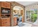This kitchen features an oven with a stone arch, a microwave, spice rack, and a large window at 1930 Country Club Rd, Eustis, FL 32726