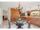 Spacious kitchen features custom cabinets, stone backsplash, and a bright dining area with backyard views at 1930 Country Club Rd, Eustis, FL 32726