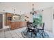 Bright kitchen featuring an island with seating, granite countertops, tile floors and an adjacent breakfast nook at 1930 Country Club Rd, Eustis, FL 32726