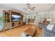 Comfortable living room with hardwood floors, large entertainment center and a view into dining room at 1930 Country Club Rd, Eustis, FL 32726