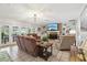 Bright living room with a stone fireplace, built-in shelves, and access to the outdoor area at 1930 Country Club Rd, Eustis, FL 32726