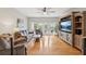 Bright living room with hardwood floors, entertainment center, and french doors to the backyard at 1930 Country Club Rd, Eustis, FL 32726