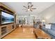 Comfortable living room with hardwood floors, large entertainment center and a view into dining room at 1930 Country Club Rd, Eustis, FL 32726