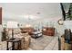 Spacious living room with comfortable seating, a fireplace, and large windows for ample natural light at 1930 Country Club Rd, Eustis, FL 32726