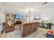 Comfortable living room with a stone fireplace, built-in shelves, and neutral-toned furniture at 1930 Country Club Rd, Eustis, FL 32726