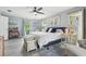 Bright main bedroom with cool gray walls, area rug, and lots of natural light at 1930 Country Club Rd, Eustis, FL 32726