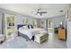 Spacious main bedroom featuring cool gray tones, two large windows, and a ceiling fan at 1930 Country Club Rd, Eustis, FL 32726