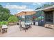 Covered patio with outdoor seating, an umbrella, and views of the screened-in pool area at 1930 Country Club Rd, Eustis, FL 32726